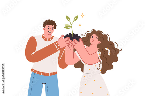 Couple grows tree, holding handful of soil with plant in hands, metaphor caring for relationship