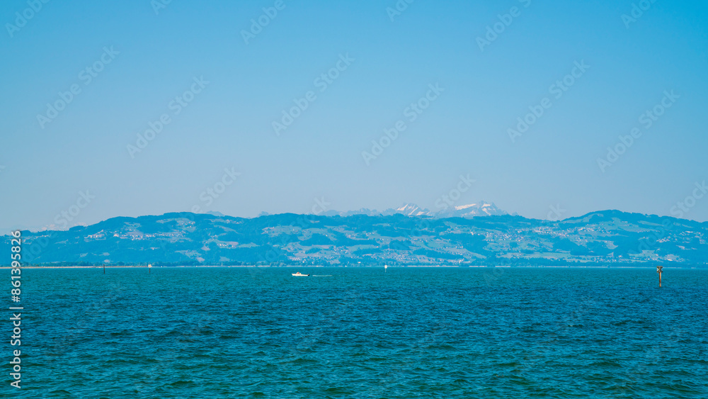 Germany, Alps mountains nature landscape behind water of bodensee lake, panorama view from lindau to swiss coast and saentis mountain with snow