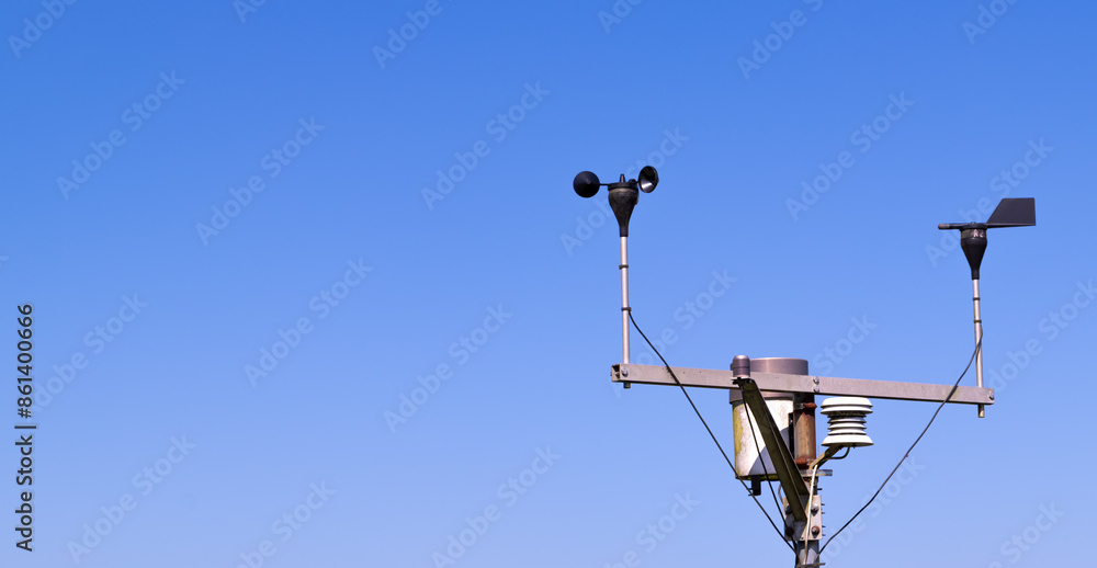 Close-up of an anemometer for measuring wind speed, a small weather station. Anemometer on a blue sky background, copy space Close-up of an anemometer for measuring wind speed, a small weather station. Anemometer on a blue sky background, copy space