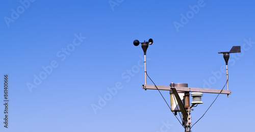 Close-up of an anemometer for measuring wind speed, a small weather station. Anemometer on a blue sky background, copy space photo