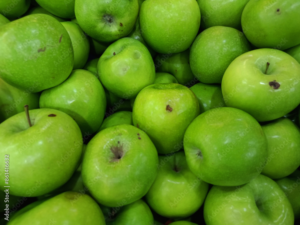 high-resolution image of a bunch of fresh, green apples closely packed together. The apples are glossy and vibrant, with smooth and slightly dimpled skins. high-resolution image of a bunch of fresh, green apples closely packed together. The apples are glossy and vibrant, with smooth and slightly dimpled skins.