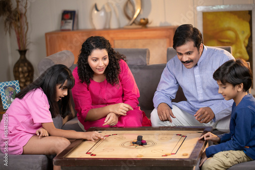 Parents Playing Carrom Board Game With Kids