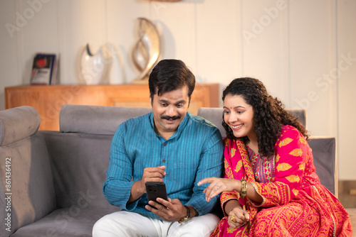 Smiling Couple Looking At A Mobile Phone Together