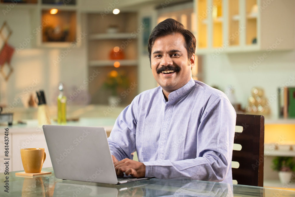 Adult Male Smiling While Working On Laptop Adult Male Smiling While Working On Laptop