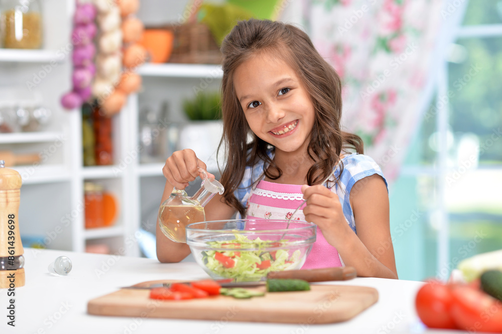 Cute happy girl coocking salad on kitchen Cute happy girl coocking salad on kitchen