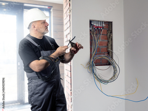 Man electrician at work. En...