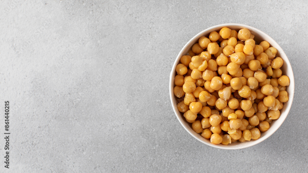 Canned chickpeas in small bowl on light grey background. Copy space Canned chickpeas in small bowl on light grey background. Copy space