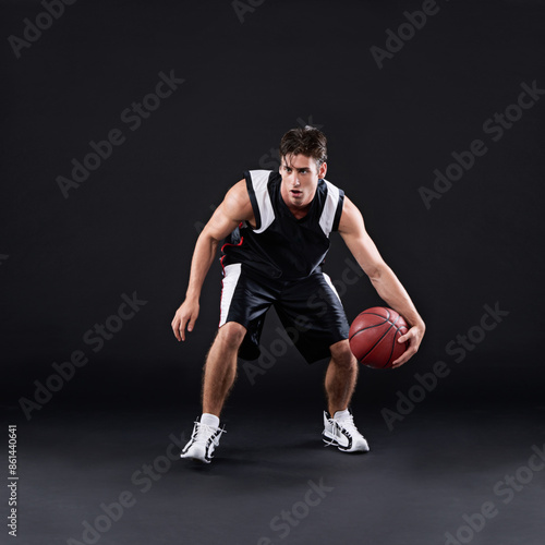 Basketball, dribbling and man in dark studio for sports, fitness exercise or training for strong body. Male athlete, black background and workout for game in gym, night with health and wellness
