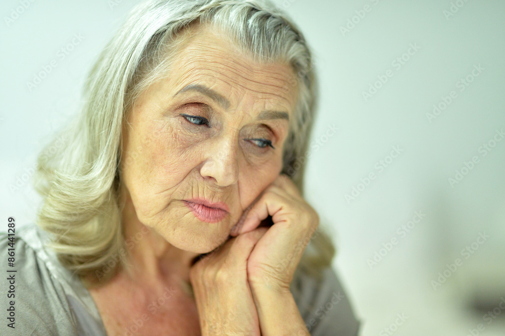 Portrait of a sad elderly woman posing at home Portrait of a sad elderly woman posing at home