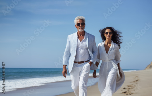 Obraz na płótnie happy mature caucasian couple walking together enjoying summer vacation, holiday at beach. Generative AI w salonie