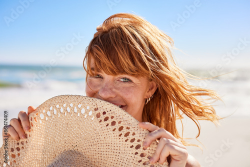 Close up face of happy young woman hides behind a straw hat