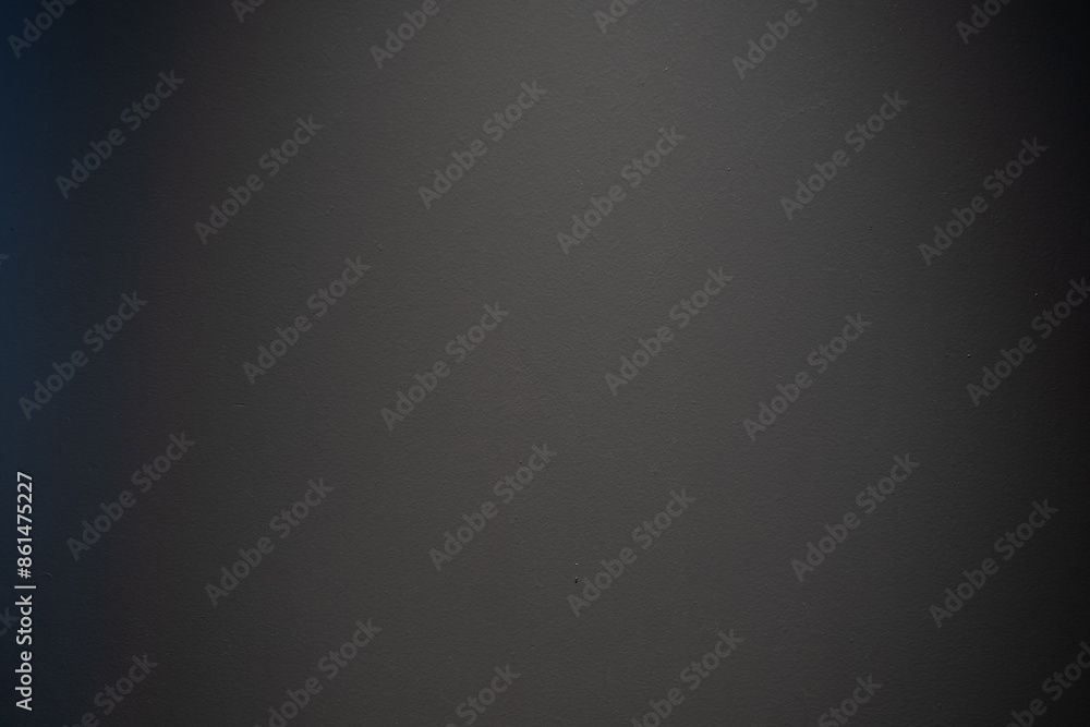 Plain dark wall surface with subtle texture and lighting, creating a minimalist background Plain dark wall surface with subtle texture and lighting, creating a minimalist background