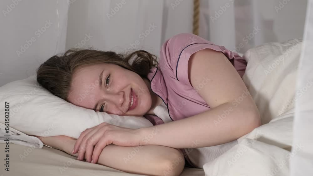 This close-up showcases a tranquil moment of a woman enjoying a peaceful break in her cozy bedroom. This close-up showcases a tranquil moment of a woman enjoying a peaceful break in her cozy bedroom.
