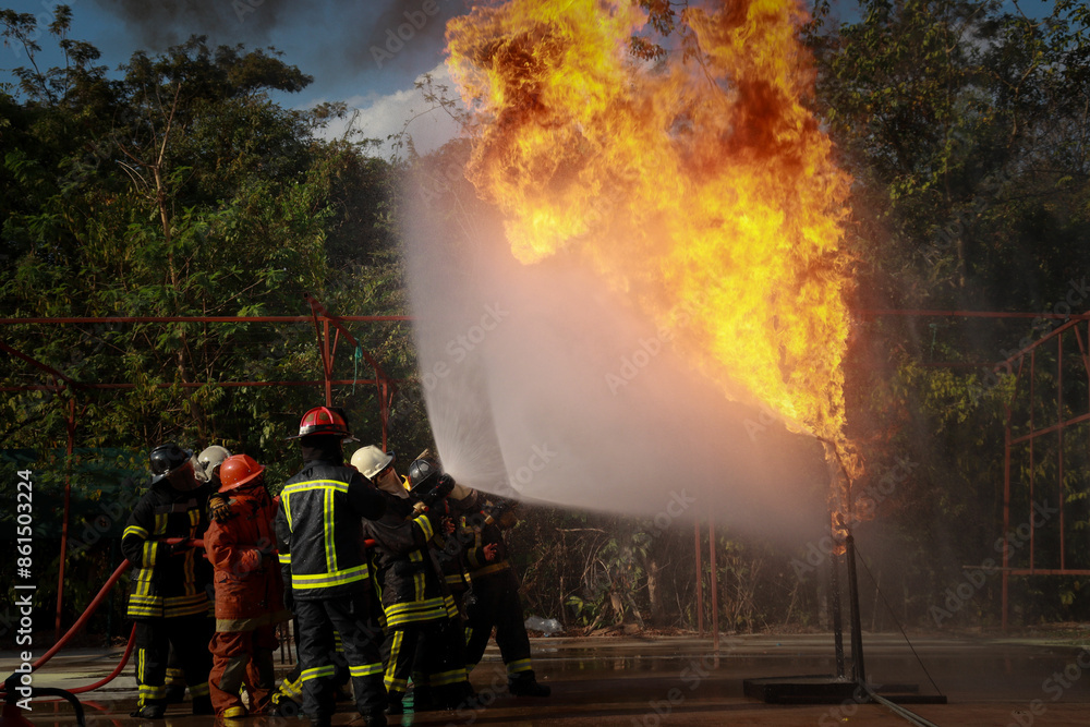 Obraz premium Firefighters, while practicing, extinguished a dangerous fire by high pressure water spray