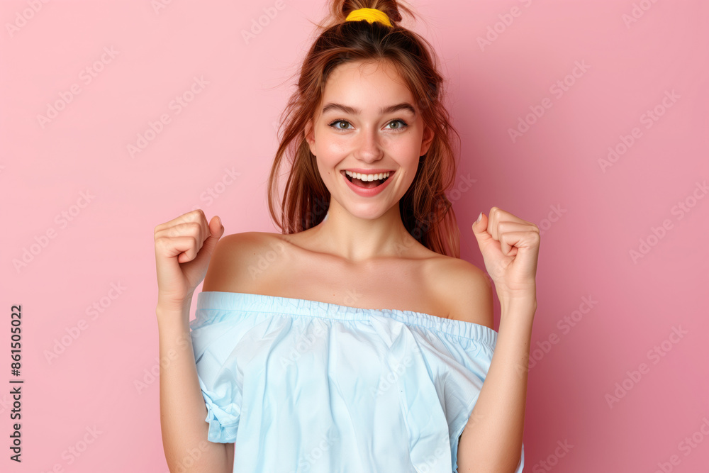 very excited girl in off-shoulder shirt smile rise her fists on isolated pink color background very excited girl in off-shoulder shirt smile rise her fists on isolated pink color background