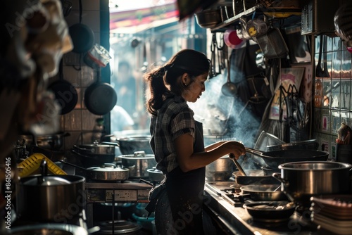 A chef is busy preparing food in a professional kitchen, using a stove and culinary equipment and utensils AIG58