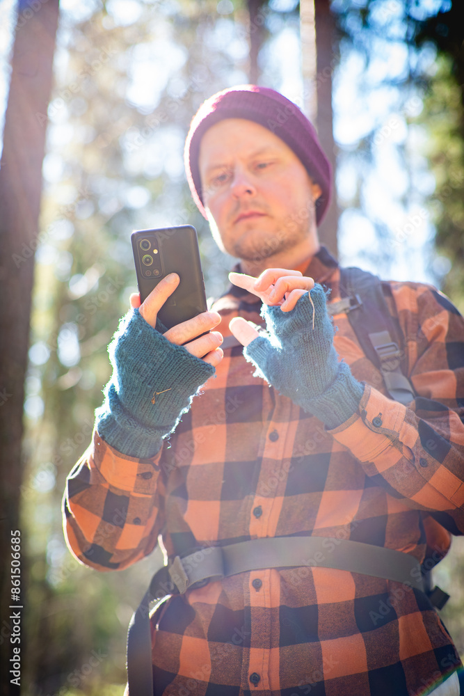 hiker using a smartphone to navigate in the wild hiker using a smartphone to navigate in the wild