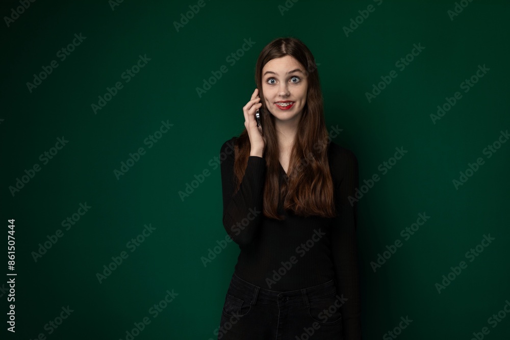 Woman Talking on Cell Phone in Front of Green Wall Woman Talking on Cell Phone in Front of Green Wall
