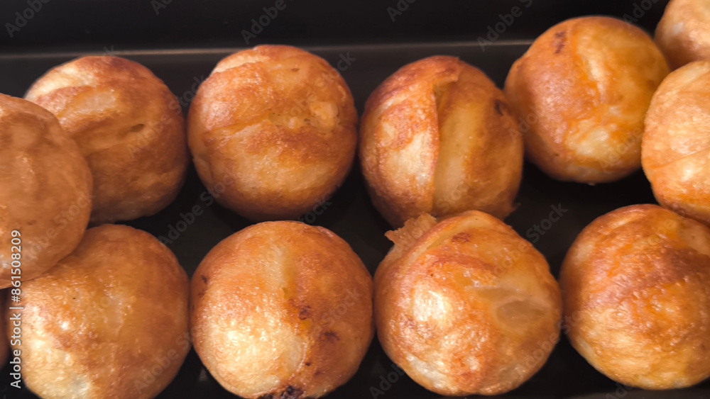 Takoyaki snacks on a black tray, Japanese style food Takoyaki snacks on a black tray, Japanese style food