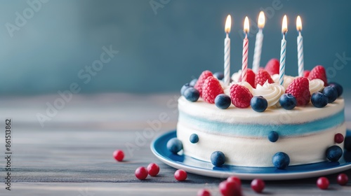 Beautifully decorated birthday cake with lit candles photo