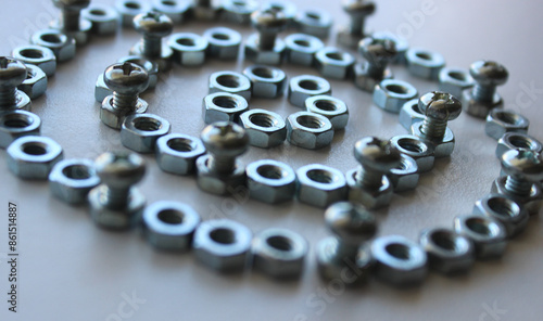 Εκτύπωση καμβά Concentrically arranged iron color nuts with bolts inserted into them reminiscen