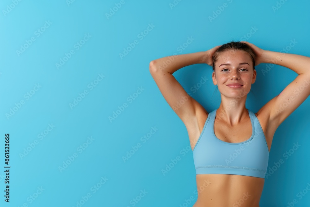 Young fitness woman doing sport showing strength gesture with arms, symbol of feminine power
