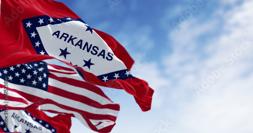 Close-up of Arkansas state flags waving with the American flag on a clear day