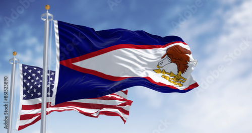 The American Samoa flags waving with american flag on a clear day photo