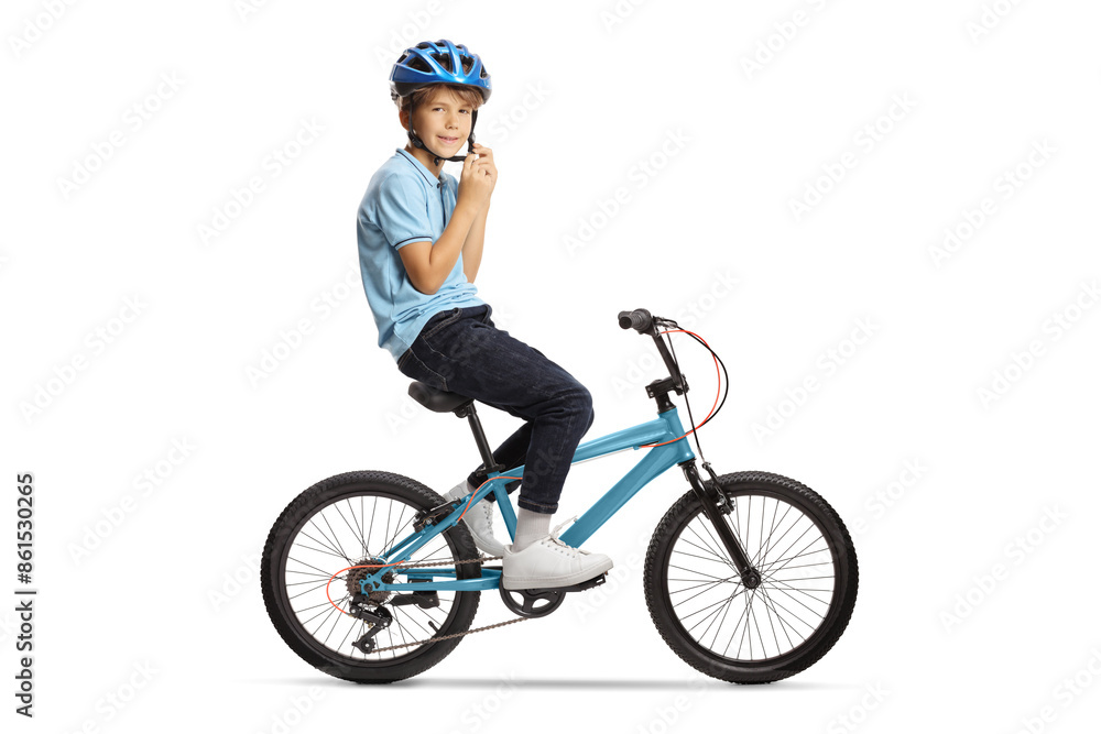 Boy putting on a helmet and sitting on a bicycle Boy putting on a helmet and sitting on a bicycle