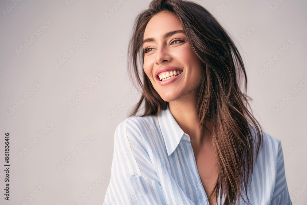 Fototapeta premium portrait of a smiling woman in casual attire with a light background and ample copy space for text or graphics overlay in various design contexts