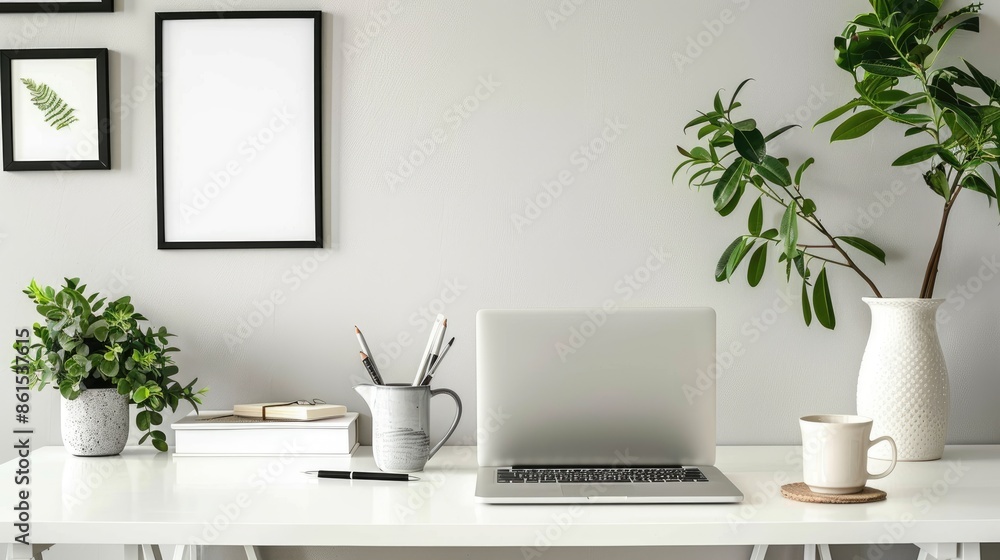 A white desk with a black coffee mug, a framed picture, a tablet, and a plant in a vase A white desk with a black coffee mug, a framed picture, a tablet, and a plant in a vase