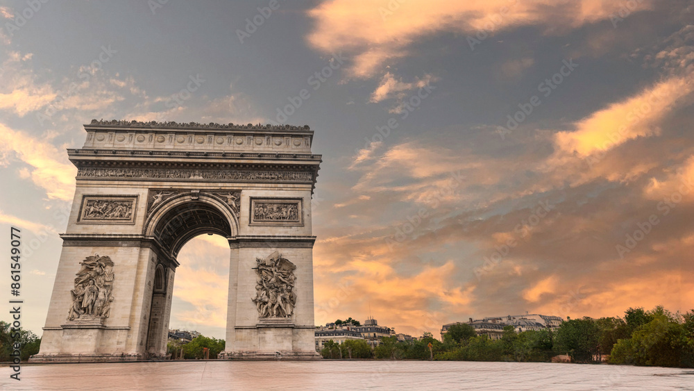 Obraz premium Famous Arc de Triomphe against nice blue sky Arc de Triomphe monument at at the western end of the Champs-elysees road in Paris, France
