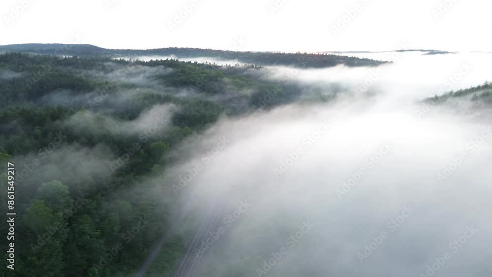 Above the clouds,. Foggy, misty morning over a mountain forest, captured by a drone's FPV shot. Above the clouds,. Foggy, misty morning over a mountain forest, captured by a drone's FPV shot.