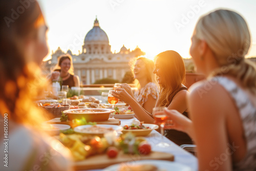  A travel photographer's dream - a rooftop dinner party in Rome in the warm glow of an autumn sunset. Friends connect over a table with fresh Italian food, with the breathtaking city as their backdrop