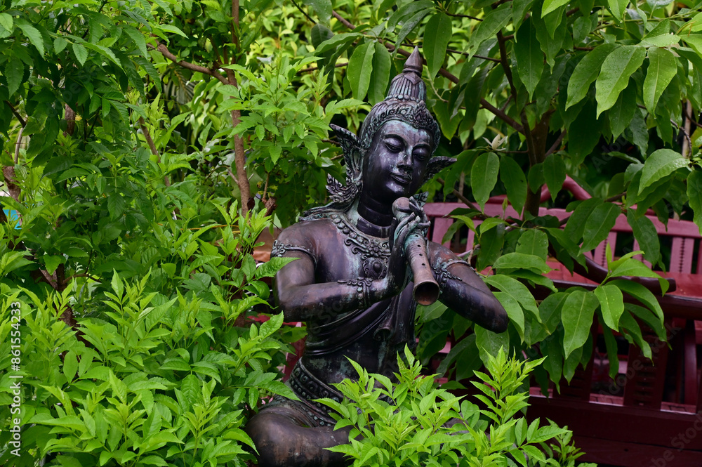 Obraz premium UTTARADIT, THAILAND - July 2, 2024: The Status of Phra Aphai Mani and Sunthorn Phu for display to decorate the garden with natural background at Thailand.