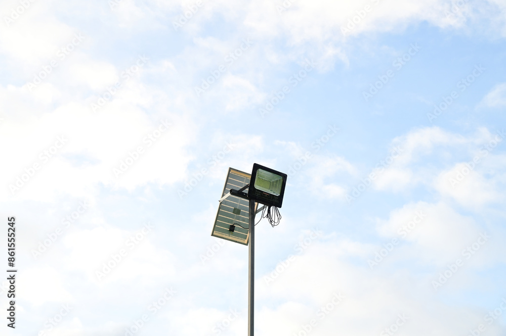 Mini Solar cell is standing outside to collect sunlight and change to be electric at night clean energy to save world with blue sky background at Thailand. Mini Solar cell is standing outside to collect sunlight and change to be electric at night clean energy to save world with blue sky background at Thailand.
