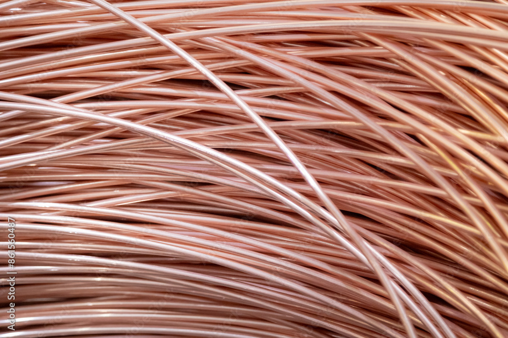 Close-up of coiled copper wires, showcasing their shiny surface and intricate overlapping pattern, captured in warm lighting.. Close-up of coiled copper wires, showcasing their shiny surface and intricate overlapping pattern, captured in warm lighting..
