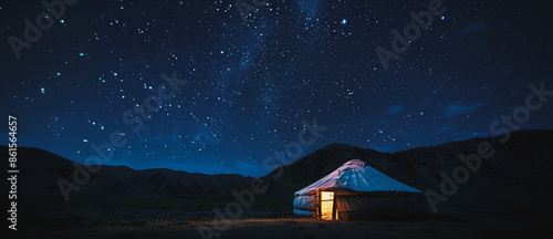 Kyrgyz yurt under a starry night sky in the mountains photo