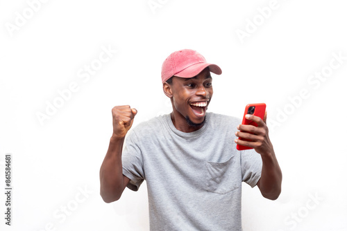 Φωτογραφία Overjoyed African man using smartphone sports betting, win money isolated on white background