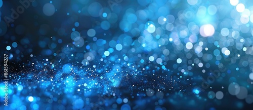 Blue particle background with abstract natural bokeh elements providing copy space image.