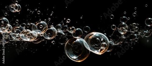 Soap bubbles creating a frothy image with a dark background for copy space.