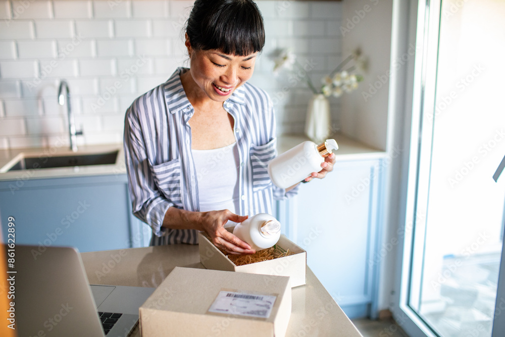 Asian Woman Unpacking Online Delivery in Kitchen Asian Woman Unpacking Online Delivery in Kitchen