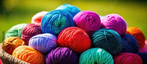 Knitting accessories like colorful yarn balls, illustrating a needlework project, with room for a custom image. with copy space image. Place for adding text or design