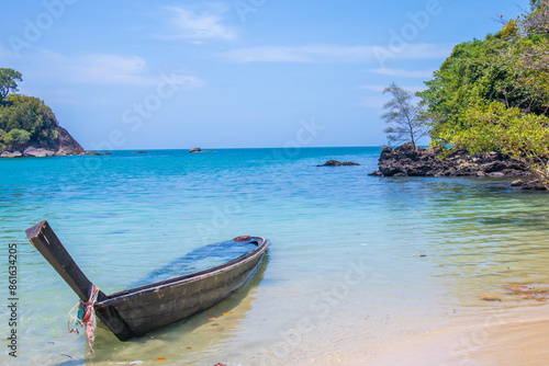 Beautiful sandy beach with long tail boats anchored on the beach of Koh Kamtok, Ranong Province, Thailand, Asia