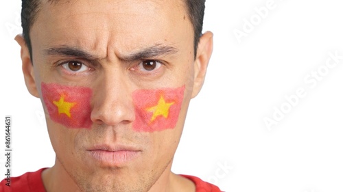 Canvas Print Serious man with a vietnamese flag painted on the face