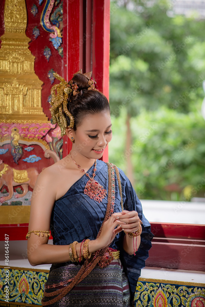 Woman wearing Thai dress visits beautiful temple in Thailand. Woman wearing Thai dress visits beautiful temple in Thailand.