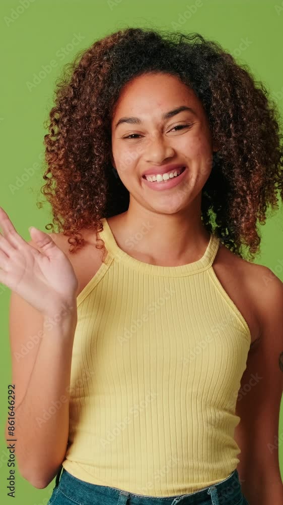 African American girl waving her hand and smiling African American girl waving her hand and smiling