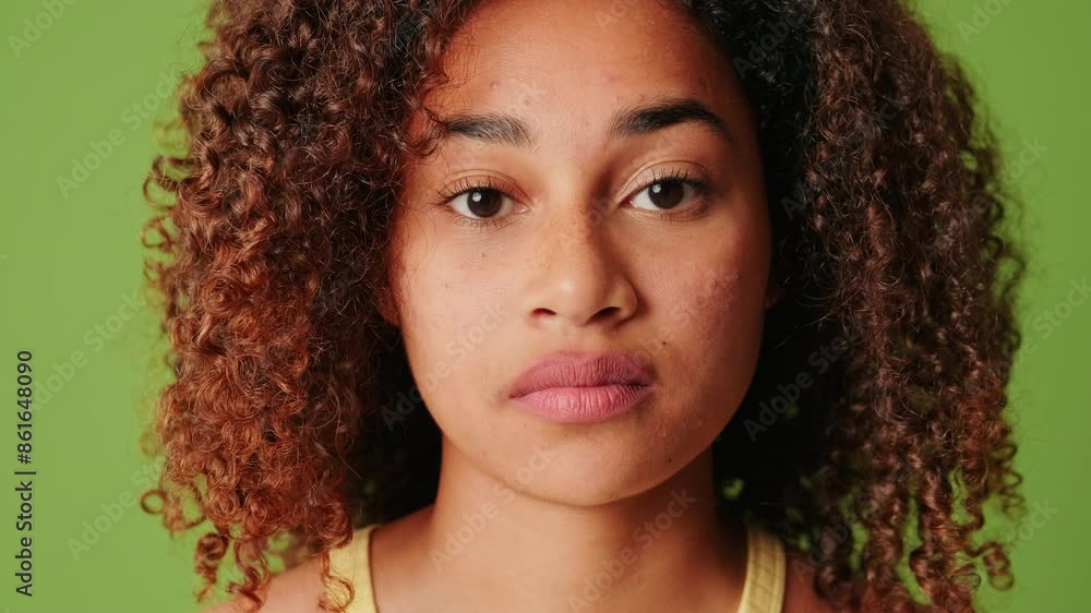 Close up portrait of an African American girl with expressive slightly sad eyes Close up portrait of an African American girl with expressive slightly sad eyes