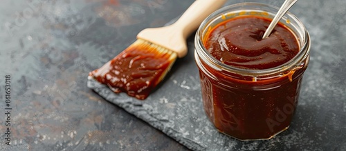 A glass jar of barbecue sau...