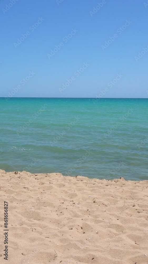 Calm ocean water lapping gently on a tropical beach on a sunny day Calm ocean water lapping gently on a tropical beach on a sunny day